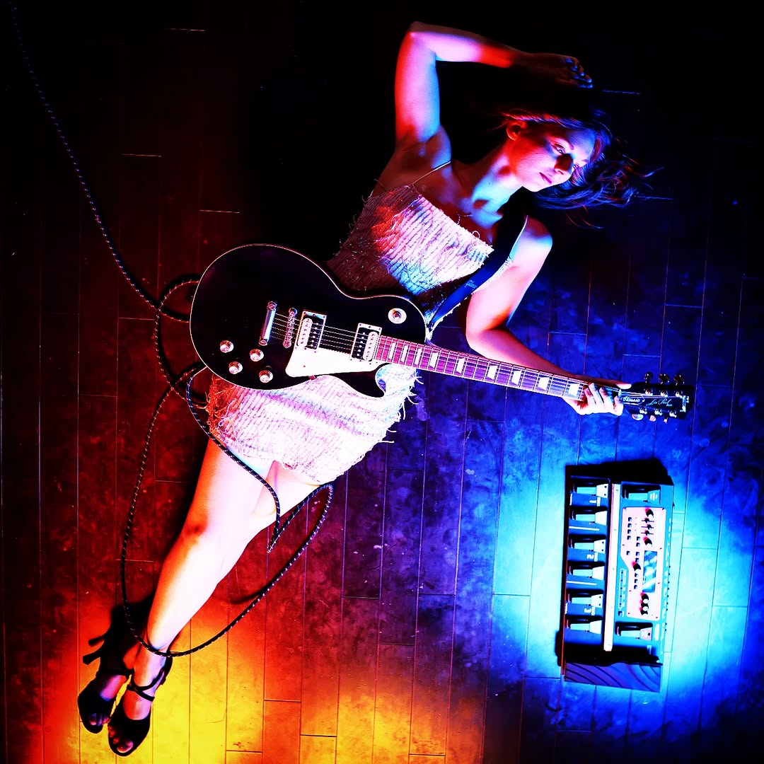 Awake & Dreaming Sasha Kristoff laying with guitar